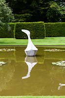 The Pond Garden: Formal pool surrounded by hedge of Taxus baccata. Sculpture of White marble called 'Hokusai's Boat' by Jessica Walters, Farleigh House, Farleigh Wallop, Hampshire. June. Designer Georgina Langton.