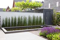 Wall with Calamagrostis x acutiflora 'Karl Foerster' and a rectangular raised pond
