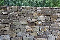 Detail of drystone boundary wall in a country garden