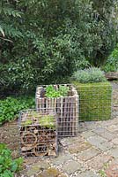 Freshly made and planted containers filled with Broadleaf Thyme, French Marjoram, Salvia, Mentha Maroccan and Lavandula Stoechas and natural materials to create insect hotel