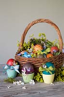 Decoarted dyed Easter eggs with ribbon, daintry flowers and string