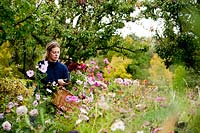 Woman in Autumn garden. Rosendals Tratgard. Stockholm. Sweden