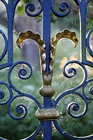 Hanham Court Gardens, Bristol. Cobwebs on ornate metal gates