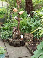 Various path textures are in place in the garden with concrete and bark covered paths meeting with a rustic artwork placed at strategic points to provide interest. Child interest is maintained with wooden carvings of fantasy creatures - Fairy Princess