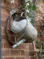 Old metal garden tools are used as rustic artwork.
