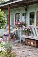 Platform of 1882 Victorian railway carriage, with potted Pelargoniums and Dianthus