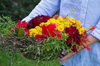 Carrying flowers in basket for making a handtied bouquet.