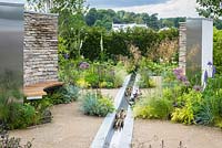 Dry stone wall, wooden bench seat, water feature rill channel and beds of herbaceous perennials, grasses, shrubs and trees - Cruse Bereavement Care: 'A Time for Everything' - RHS Chatsworth Flower Show 2017 - Designer: Neil Sutcliffe - Sponsor: London Stone