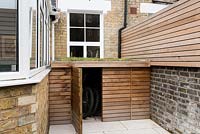 Cedar panelled bike shed and fence