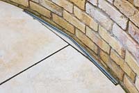 Detail of brick wall, paving and drainage