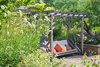 Wooden swing seat with Rosa, Salvia and Giant Scabious