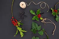 Ingredients needed to create hanging christmas decoration with berries and star cutting shape