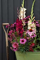 Floral arrangement in tin container with Echinacea, Gladiolus, Cotinus, Berberis and Euphorbia
