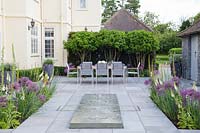 Modern rectangular water feature on patio, view to table and chairs