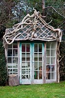 Driftwood summerhouse in Charlotte and Donald Molesworth's garden, Kent, UK.