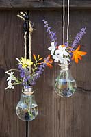 Home made hanging vase made from a lightbulb - hang two or more vases together for a pretty display