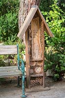 Insect hotel next to wooden bench