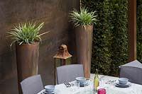 Copper feature wall and tall containers with Astelia