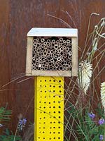 Insect hotel on a yellow pole