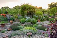 The central herb gravel garden looks out across the herbaceous planting to the pear orchards.