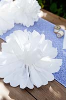 Making a paper pom pom from napkins. Continue to separate the layers of paper and pull upwards fluffing them up to make a ball