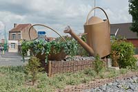 Watering can garden feature in public space along the road. Dunkirk, France. 