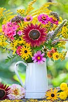 Jug of late summer flowers including Sunflowers