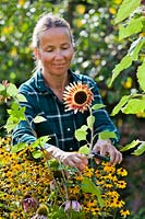 Woman cutting sunflowers