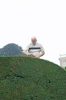 Portrait of Dirk Aneca pruning the centuries-old Yew  topiary of Bingerden Estate.