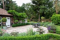 Gatehouse area with Buxus sempervirens hedge edging a patio area in a Tom Hoblyn designed garden at Heatherbrae