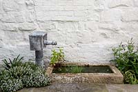 Water fountain and stone bath in patio area
