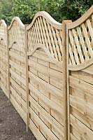 Newly erected fence with wavy trellis top