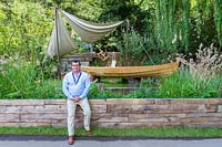 The IBTC Lowestoft Broadland Boatbuilder's Garden, featuring replica of long-boat which the college plan to reconstruct in full next year. Designer Gary Breeze in front of the garden. RHS Chelsea Flower Show 2017