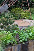 Salvaged construction materia with planting of epimedium and dwarf pines - Industrial Decay in Walker' Wharf Garden supported by Doncaster Deaf Trust -RHS Chelsea Flower Show 2017