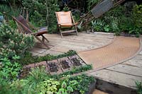 Walker's Wharf Garden supported by Doncaster Deaf Trust, view of industrial materials reused for paving and walling - RHS Chelsea Flower Show 2018