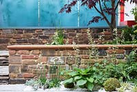 Hagakure - Hidden Leaves - Low brick wall providing seating under an Acer with Hosta , Ferns and Heuchera - RHS Chelsea Flower Show 2017
