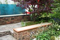  Hagakure - Hidden Leaves - Low brick wall for seating under an Acer palmatum, underplanted with Hosta and shade loving plants - RHS Chelsea Flower Show 2017