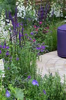 The Wellbeing of Women Garden - circular paving surrounded by purple mixed planting - RHS Hampton Court Flower Show 2015