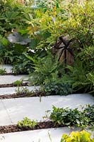 Stepping stone path with extensive damp garden planting along either side - The Macmillan Legacy Garden - RHS Hampton Court Flower Show 2015