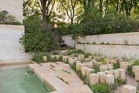 Maltese limestone blocks and mediterranean planting with Euphorbia spinosa - The M and G Garden - RHS Chelsea Flower Show 2017 - Designer: James Basson, Sponsor M and G investments