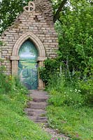 Welcome to Yorkshire, climbing pathway to ruined gothic archway with trompe d'oeil - RHS Chelsea Flower Show
