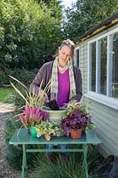 Woman adding compost to container before planting