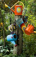 A display of colourful Watering Cans 