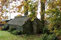 The shade house and a Beech Tree - Bourton House Garden