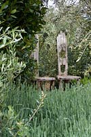 Sculptural wooden chairs surrounded by olive trees and lavender - The Retreat, RHS Malvern Spring Festival 2017
