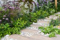 Planting along white gravel and natural stone path - BBC Gardener's World Live, Birmingham 2017 - Big Fish Landscapes Garden -Designer: Cherry Carmen, Cherry Carmen Garden Design -Gold