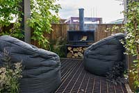 Floating lounging platform with bespoke steel wood burner and beanbags - BBC Gardener's World Live, Birmingham 2017 -Living Gardens 'Its Not Just About The Beard' Garden - Designer : Peter Cowell and Monty Richardson
