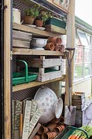 Gardening equipment on shelves in Seaview Cottage, Cornwall, UK