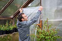 Putting up greenhouse insulation bubblewrap, October