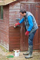 Treating a wooden shed with preservative